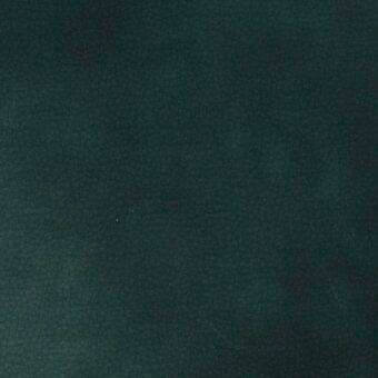 Dark teal velvet fabric swatch displaying uneven texture and tonal variations, presented against a neutral backdrop for color and material detail.